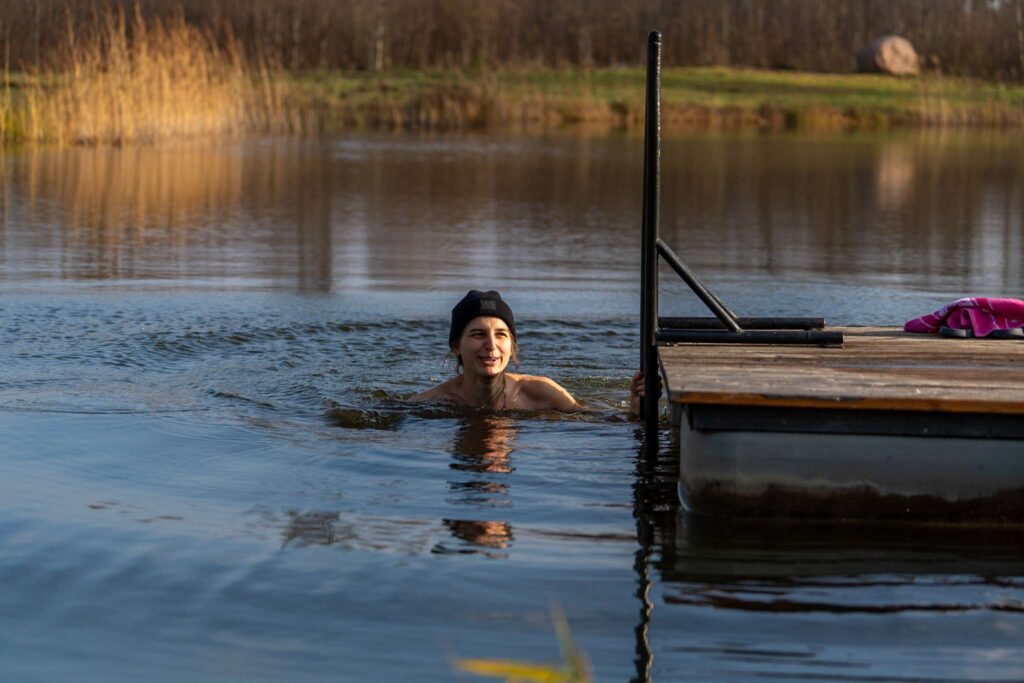 girl takes cold dip in pond in latvia