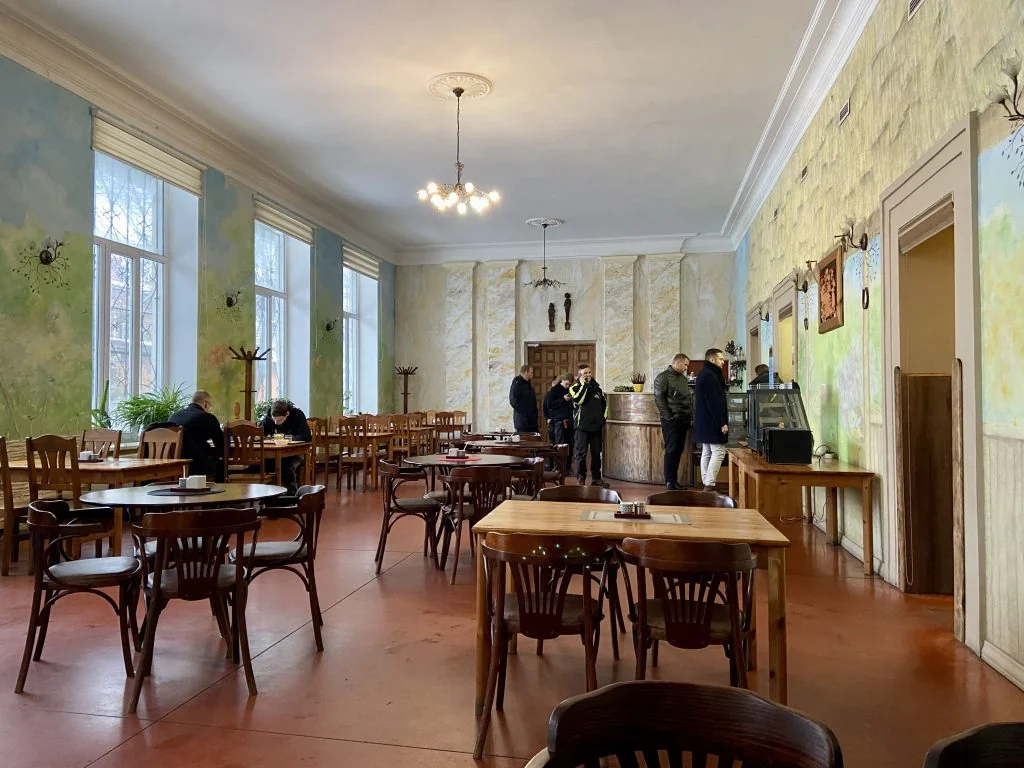 People and tables at an ednica - a canteen in Latvia