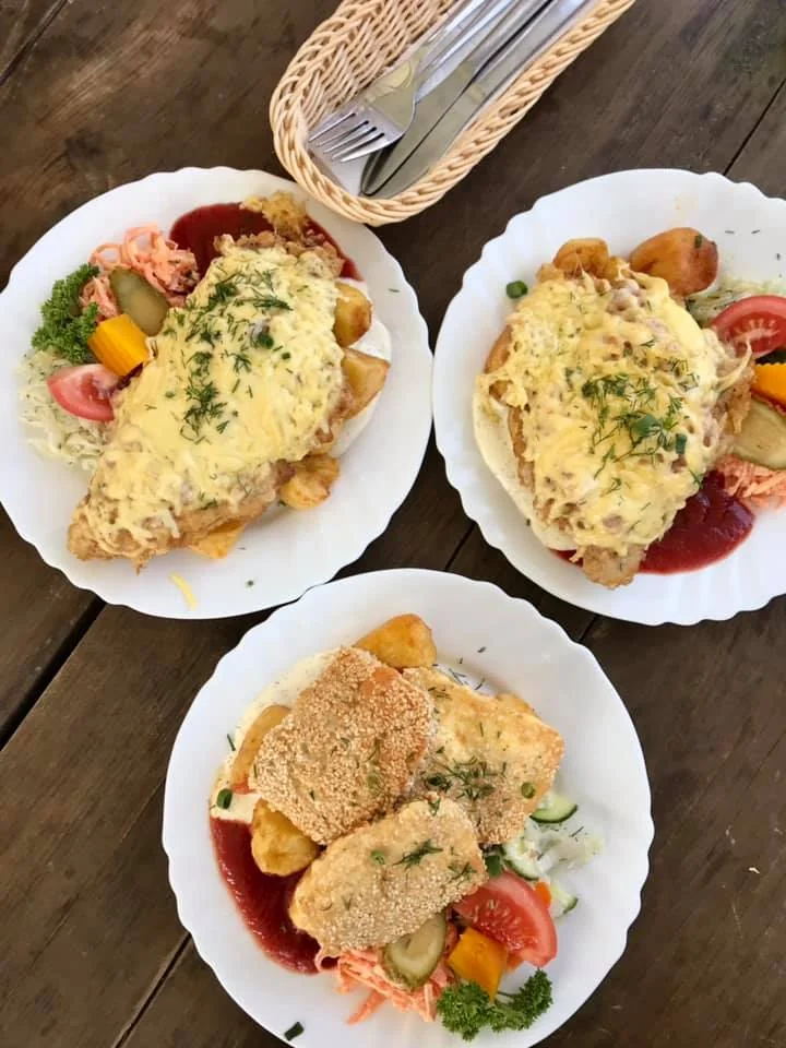 two plates of karbonade and one plate of fried cheese at a latvian cafe