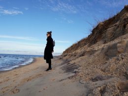 woman stands on beach in latvia